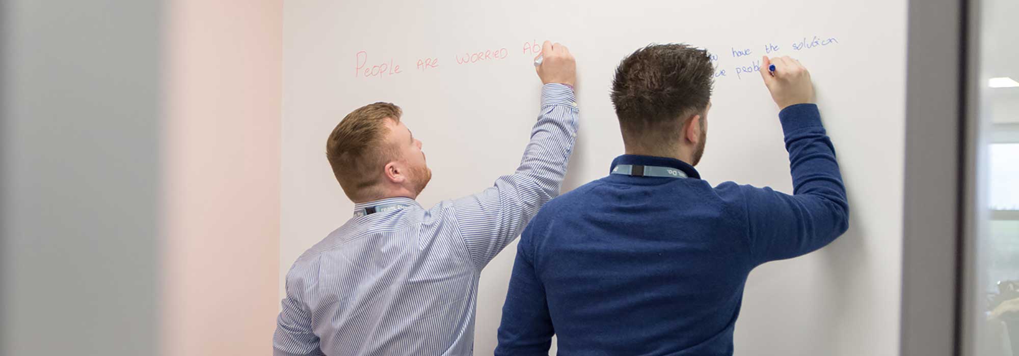 two TTM team members explain the subject on the board